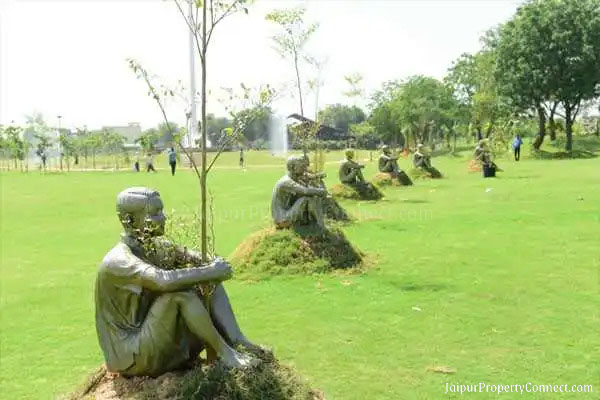 sitting man sculptures in city park Jaipur